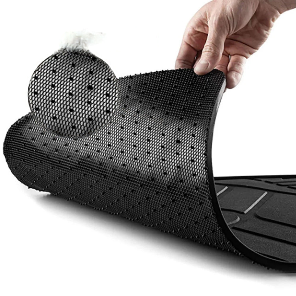 Black rubber car floor mat with pebbled texture and molded contour edges