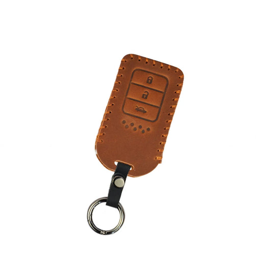 Brown leather key cover with stitched edges and three-button icon, key ring included