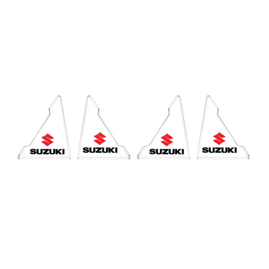 Set of four clear Suzuki triangle corner protectors with red logo.