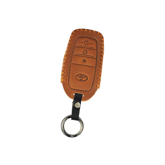 Brown leather Toyota key fob cover with button icons and metal keyring